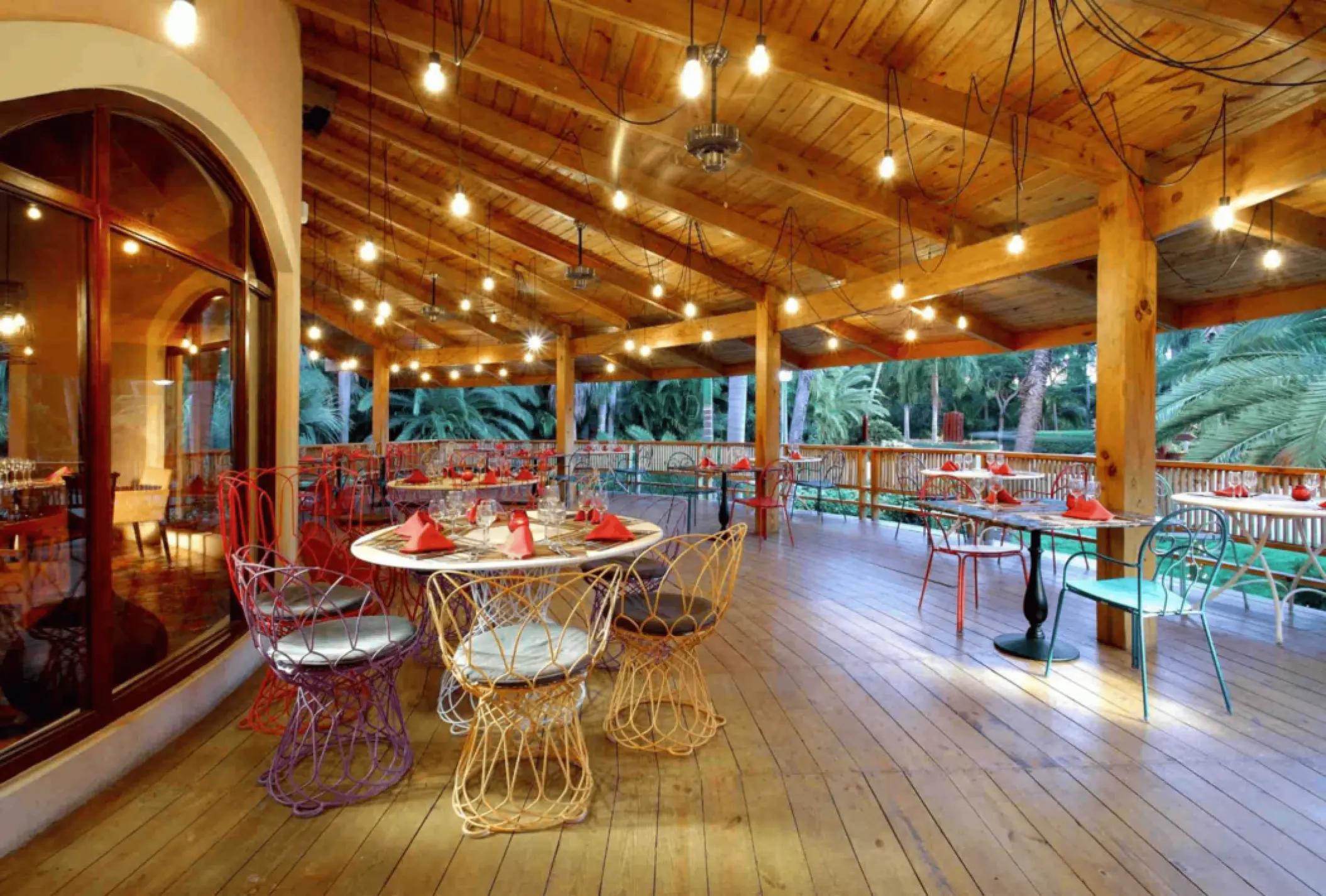 Poseidon restaurant with string lights and wooden beams at Grand Palladium Punta Cana