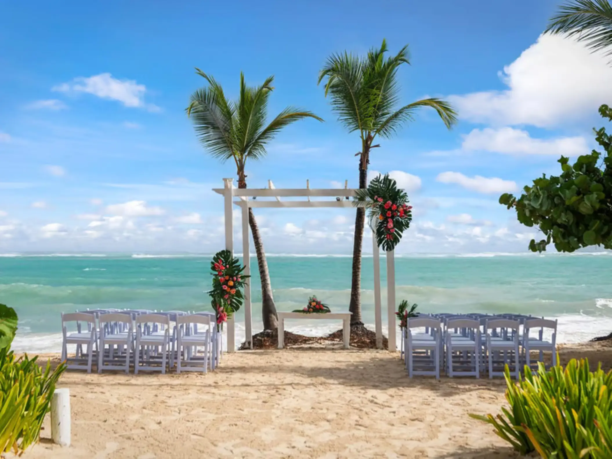 Beachfront wedding ceremony with a white pergola at Grand Palladium Punta Cana, Punta Cana