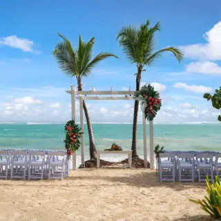 Beachfront wedding ceremony with a white pergola at Grand Palladium Punta Cana, Punta Cana