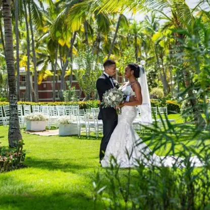 The bride and groom posing at a garden wedding ceremony venue at Grand Palladium Punta Cana