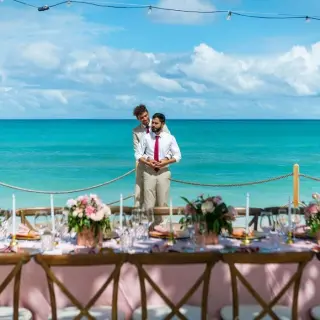 The couple standing behind a decorated wedding reception table at Grand Palladium Punta Cana