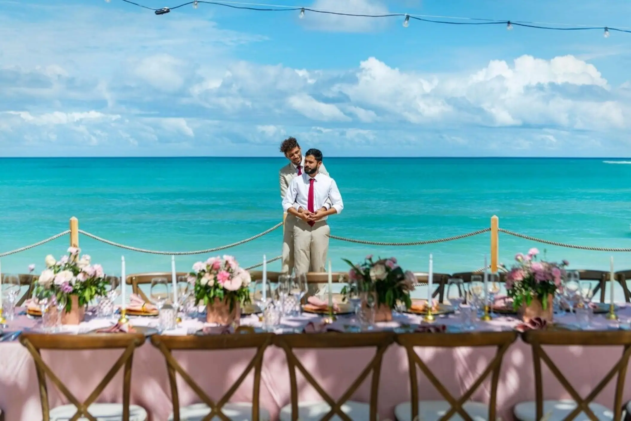 The couple standing behind a decorated wedding reception table at Grand Palladium Punta Cana