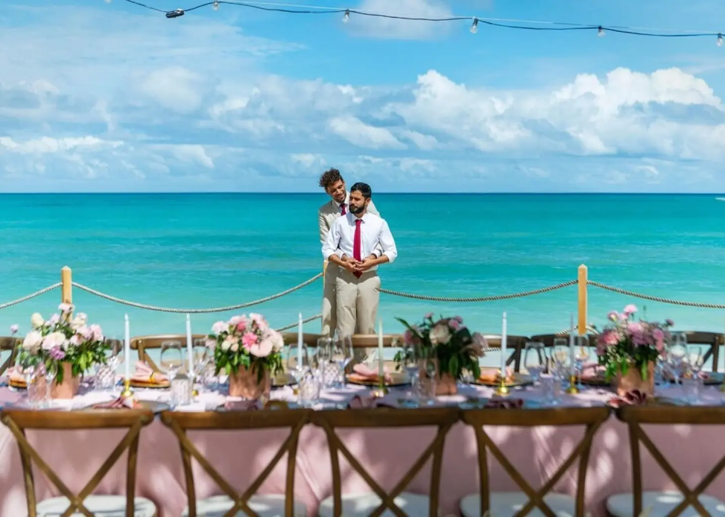 The couple standing behind a decorated wedding reception table at Grand Palladium Punta Cana