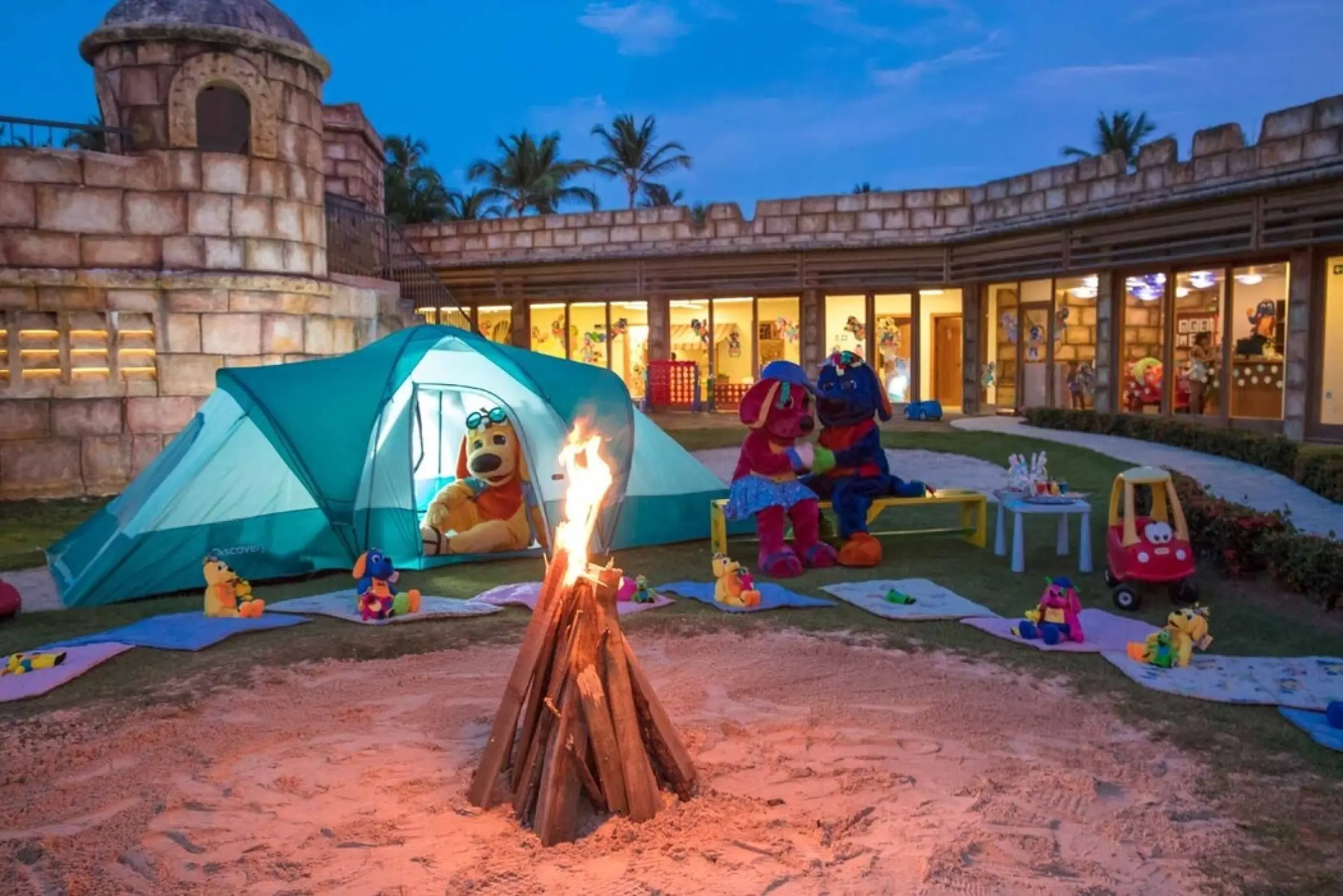 Kids club outdoor play area with a bonfire and tent at Grand Palladium Punta Cana