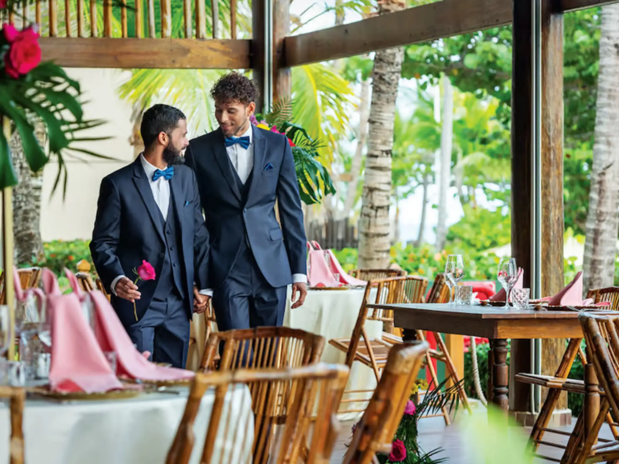 Grooms walking through an open-air wedding reception at Grand Palladium Punta Cana