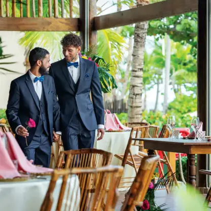 Grooms walking through an open-air wedding reception at Grand Palladium Punta Cana