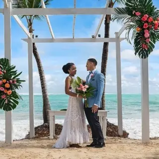 Beachfront wedding ceremony under a floral gazebo at TRS Turquesa, Punta Cana