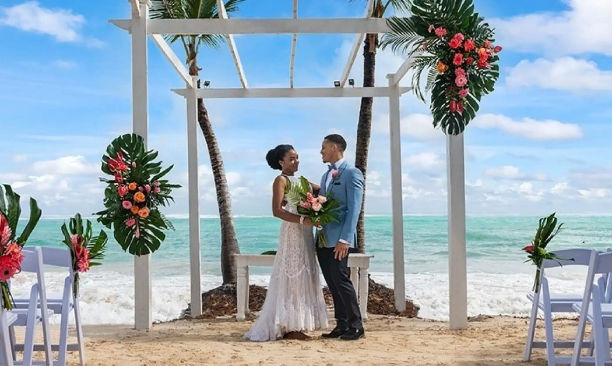 Beachfront wedding ceremony under a floral gazebo at TRS Turquesa, Punta Cana