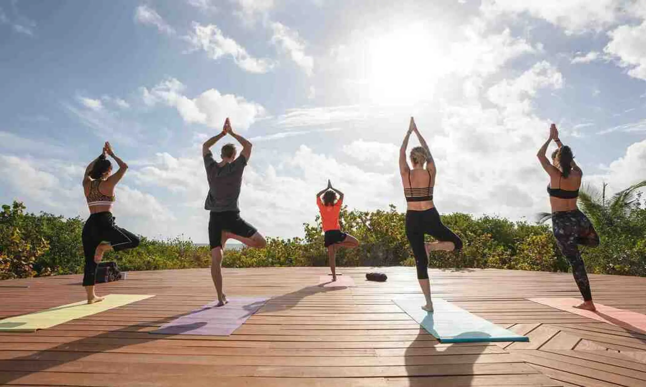 Outdoor yoga class on a wooden deck at Grand Palladium Punta Cana, Punta Cana