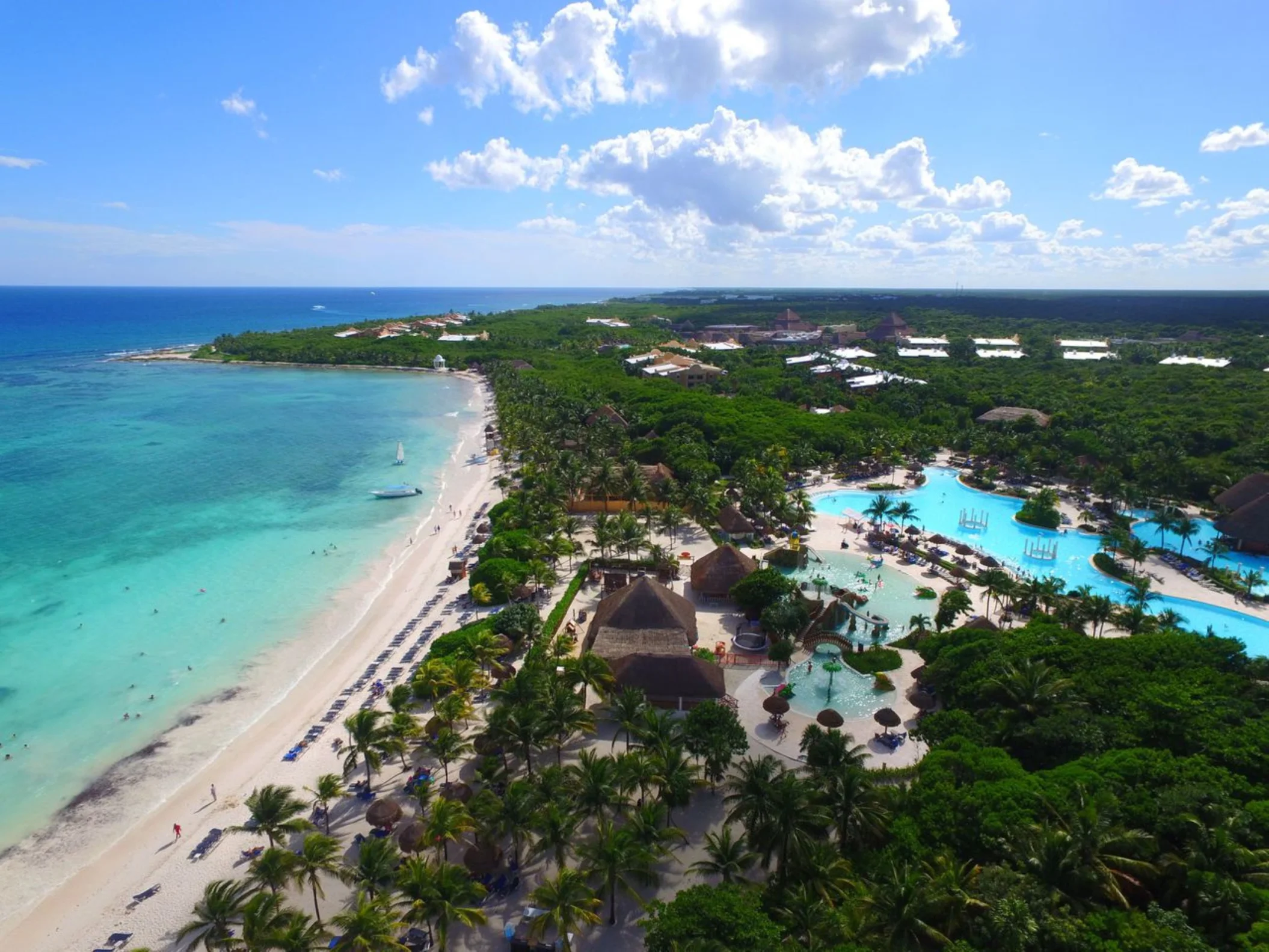 aerial view of grand palladium kantenah resort with it's beach and pools and surrounding greenery