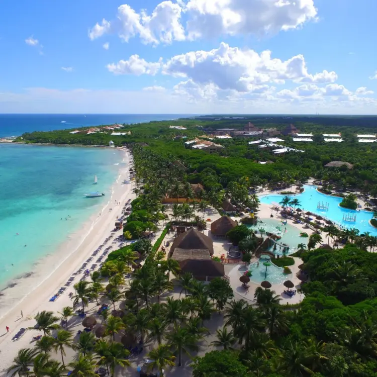 Aerial view of the beach, turquoise ocean, and swimming pools at Grand Palladium Kantenah, Riviera Maya