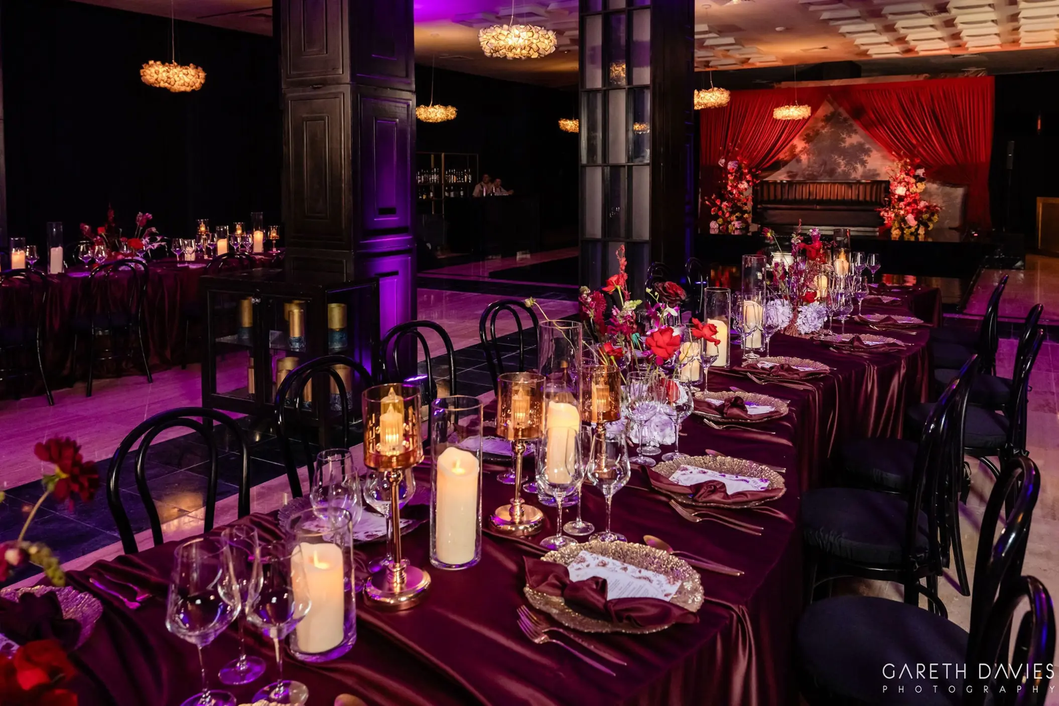 Indoor ballroom wedding reception with candlelit long tables at Grand Palladium Riviera Maya