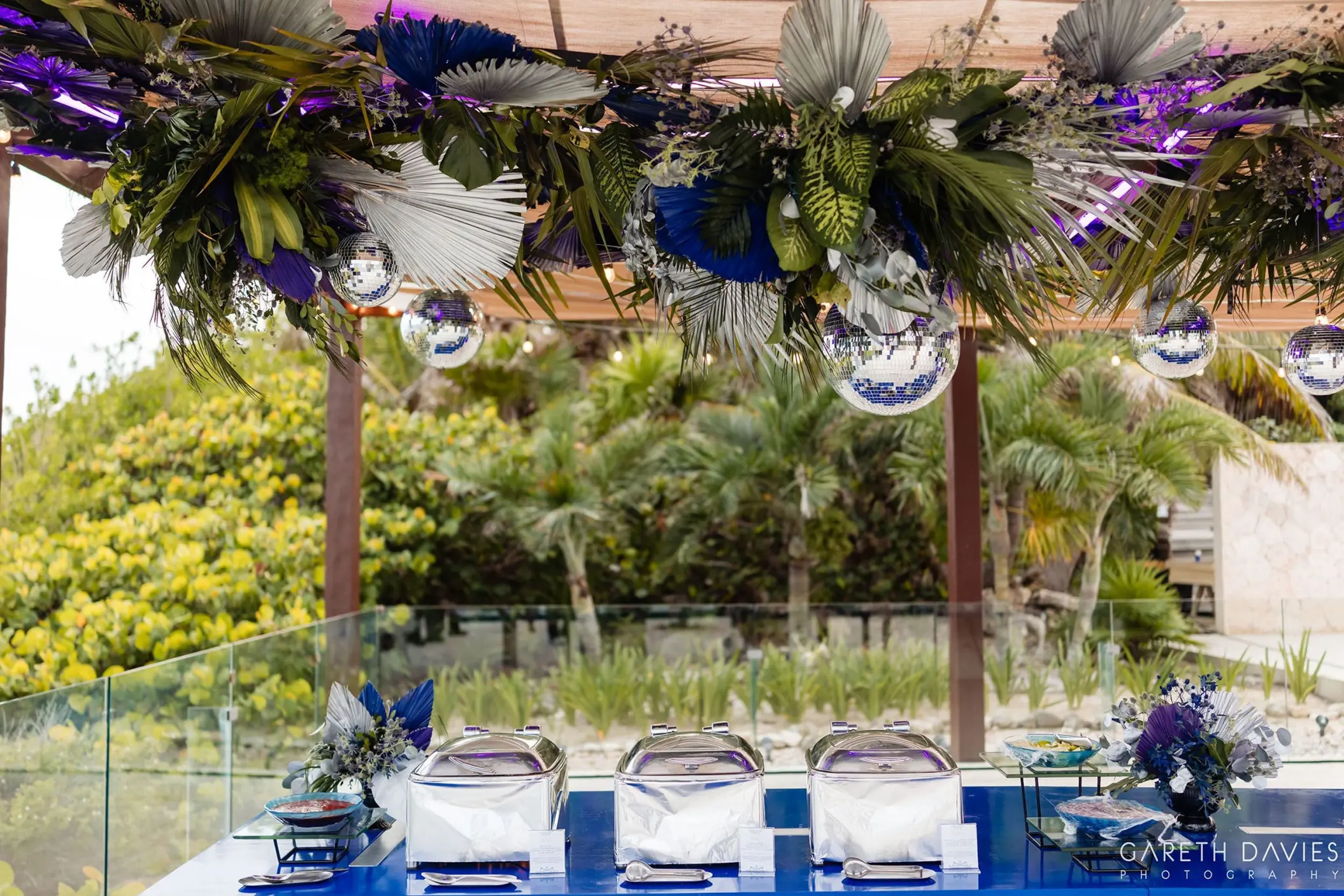 Wedding reception buffet with blue decor and floral canopy at Grand Palladium Riviera Maya