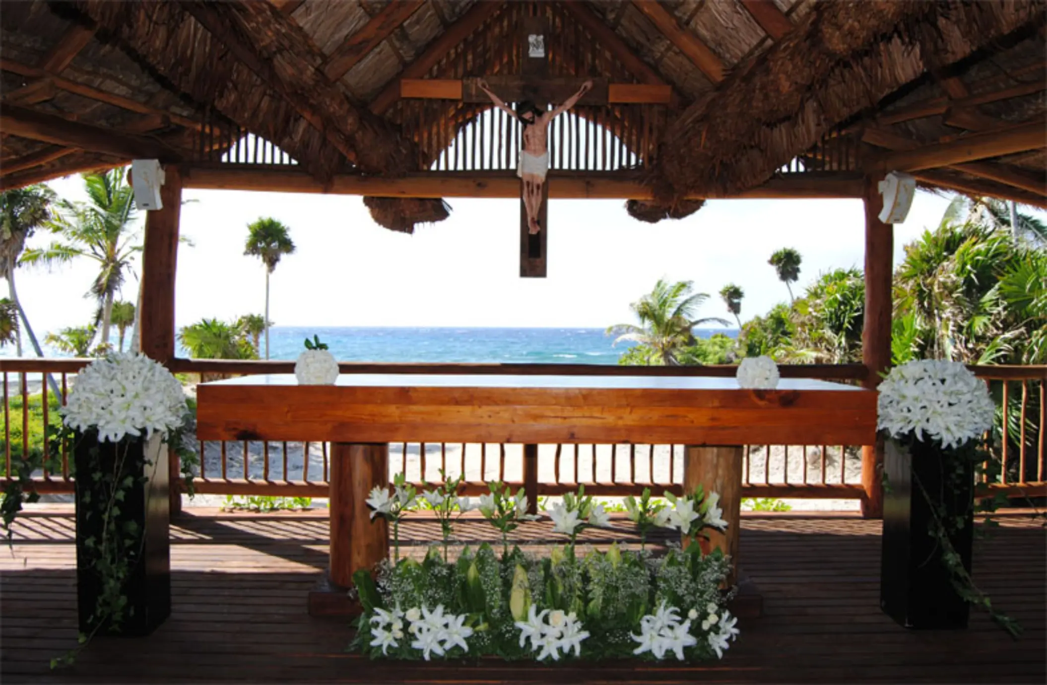 Wooden altar at the chapel of Grand Sirenis Riviera Maya with an ocean view