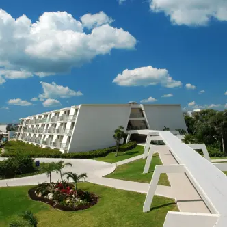 Modern white accommodation buildings and elevated walkway at Grand Sirenis Riviera Maya, Riviera Maya