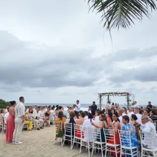 Outdoor wedding ceremony with seated guests on the sand at Grand Sirenis Riviera Maya