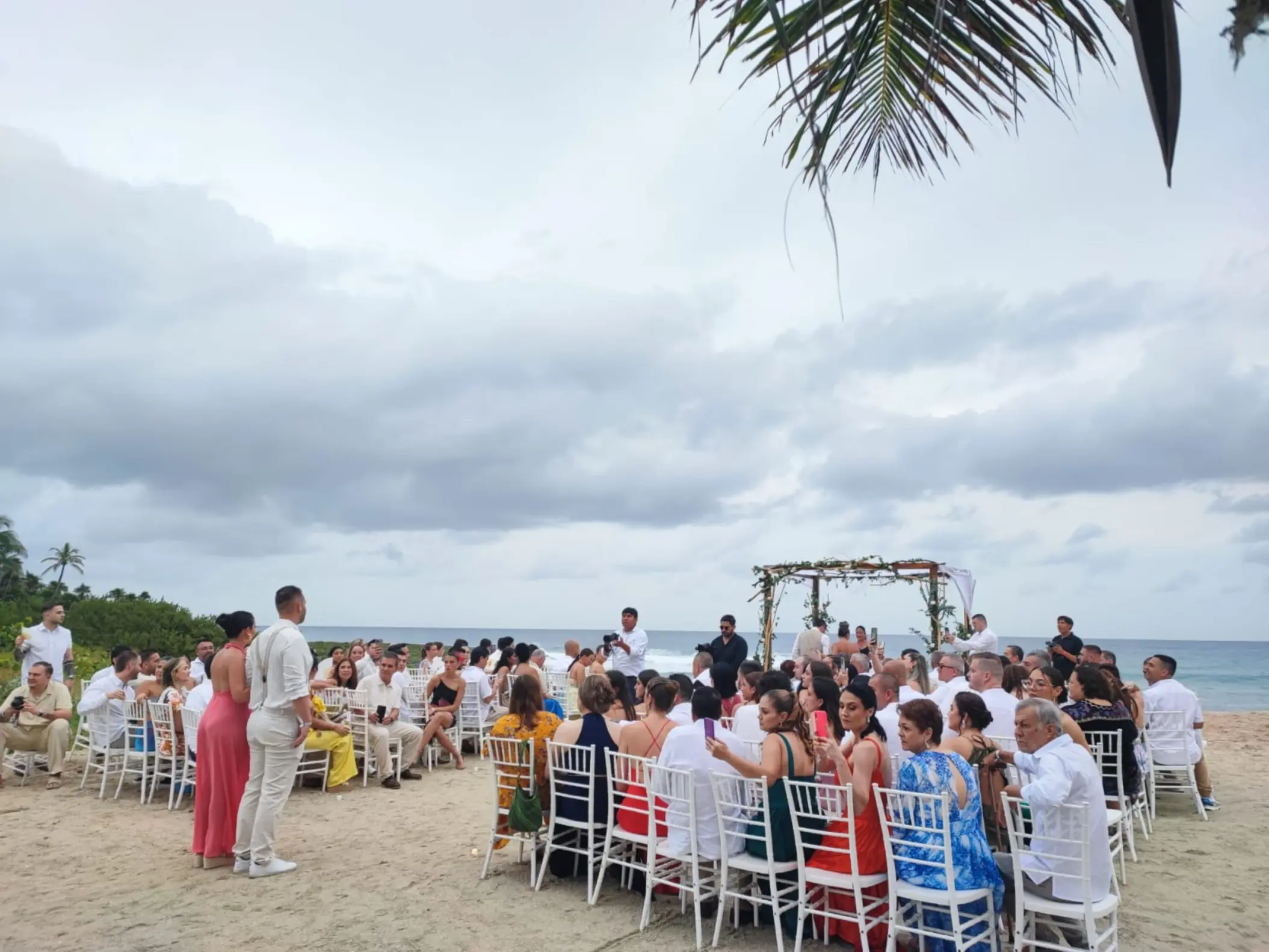 Outdoor wedding ceremony with seated guests on the sand at Grand Sirenis Riviera Maya