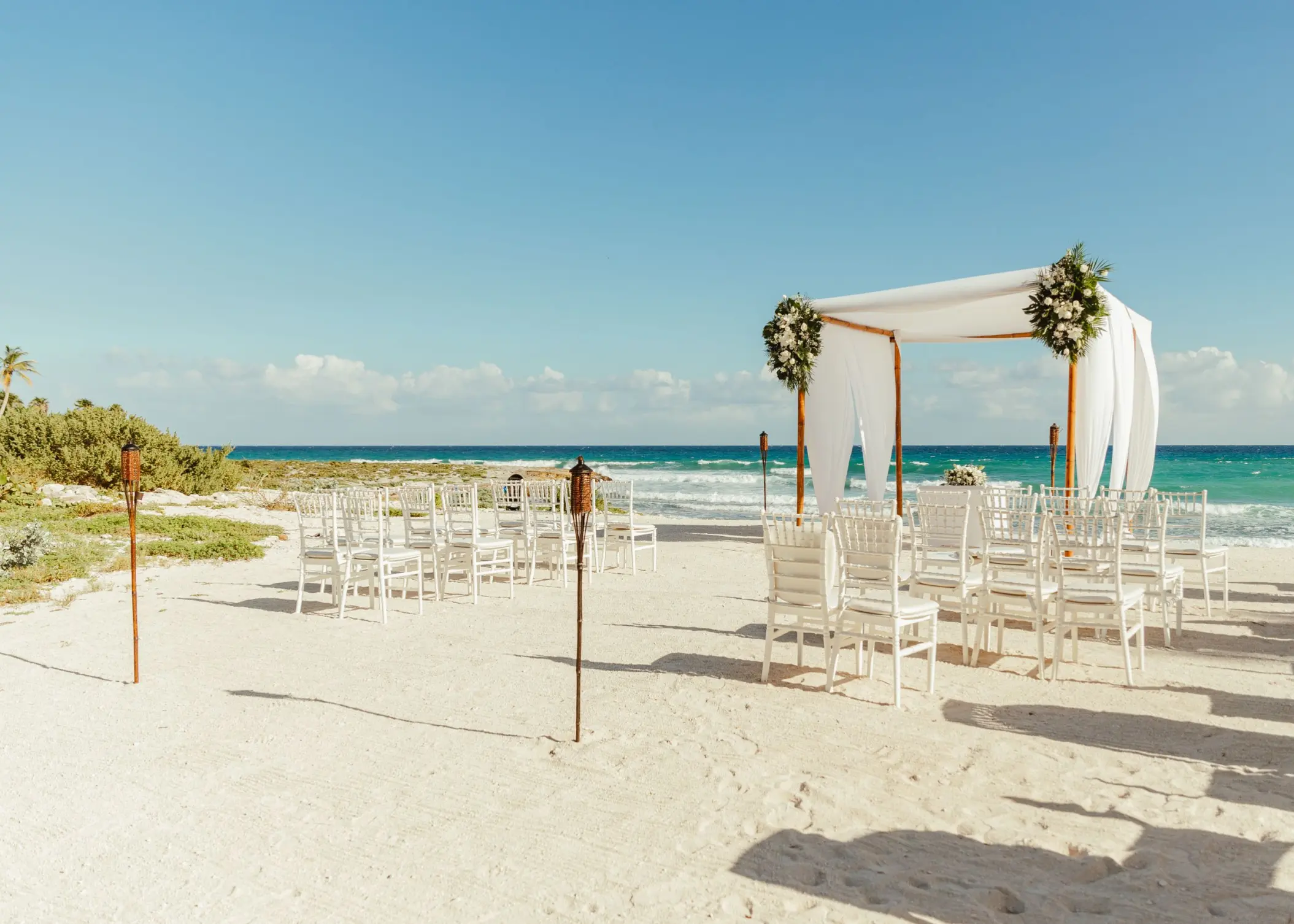 Beachfront wedding ceremony with a white huppah at Grand Sirenis Riviera Maya, Riviera Maya