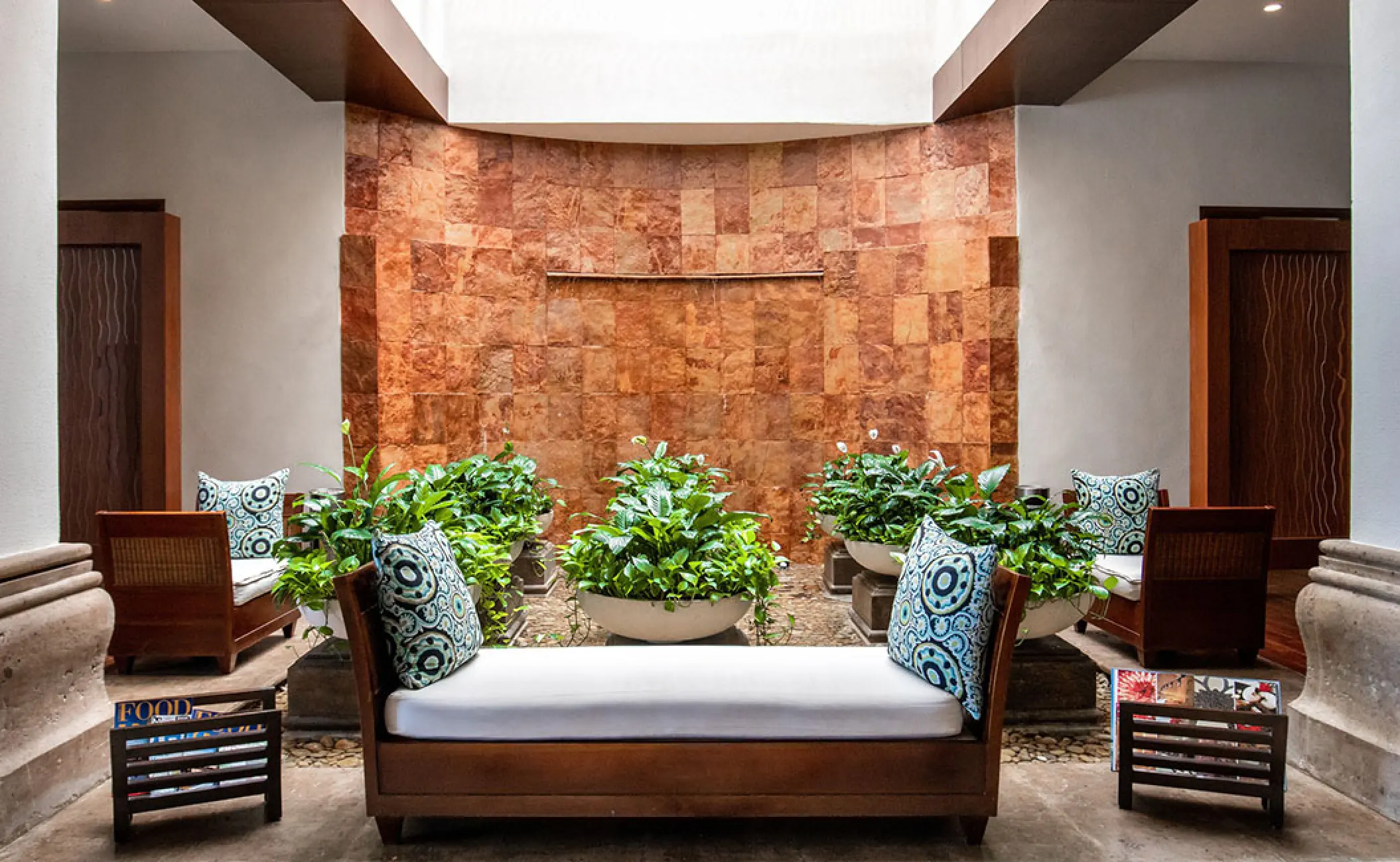Indoor lounge area with water feature and lush greenery at Grand Velas Riviera Nayarit, Puerto Vallarta