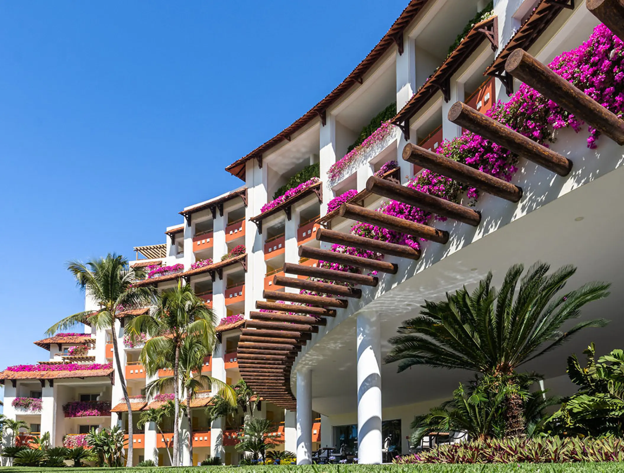 Grand Velas Riviera Nayarit balconies decorated with pink bougainvillea and palm trees, Puerto Vallarta