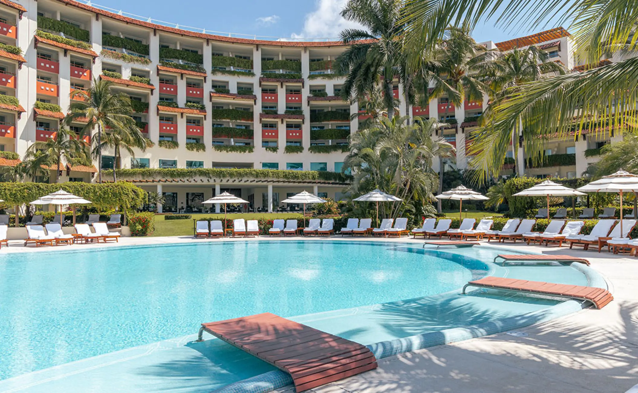 Grand Velas Riviera Nayarit tiered building and outdoor pool with sun loungers, Puerto Vallarta