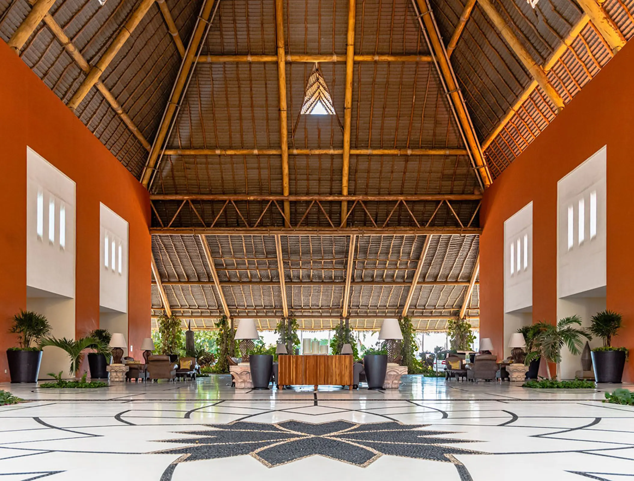Grand Velas Riviera Nayarit lobby featuring high vaulted palapa ceiling and terracotta walls, Puerto Vallarta