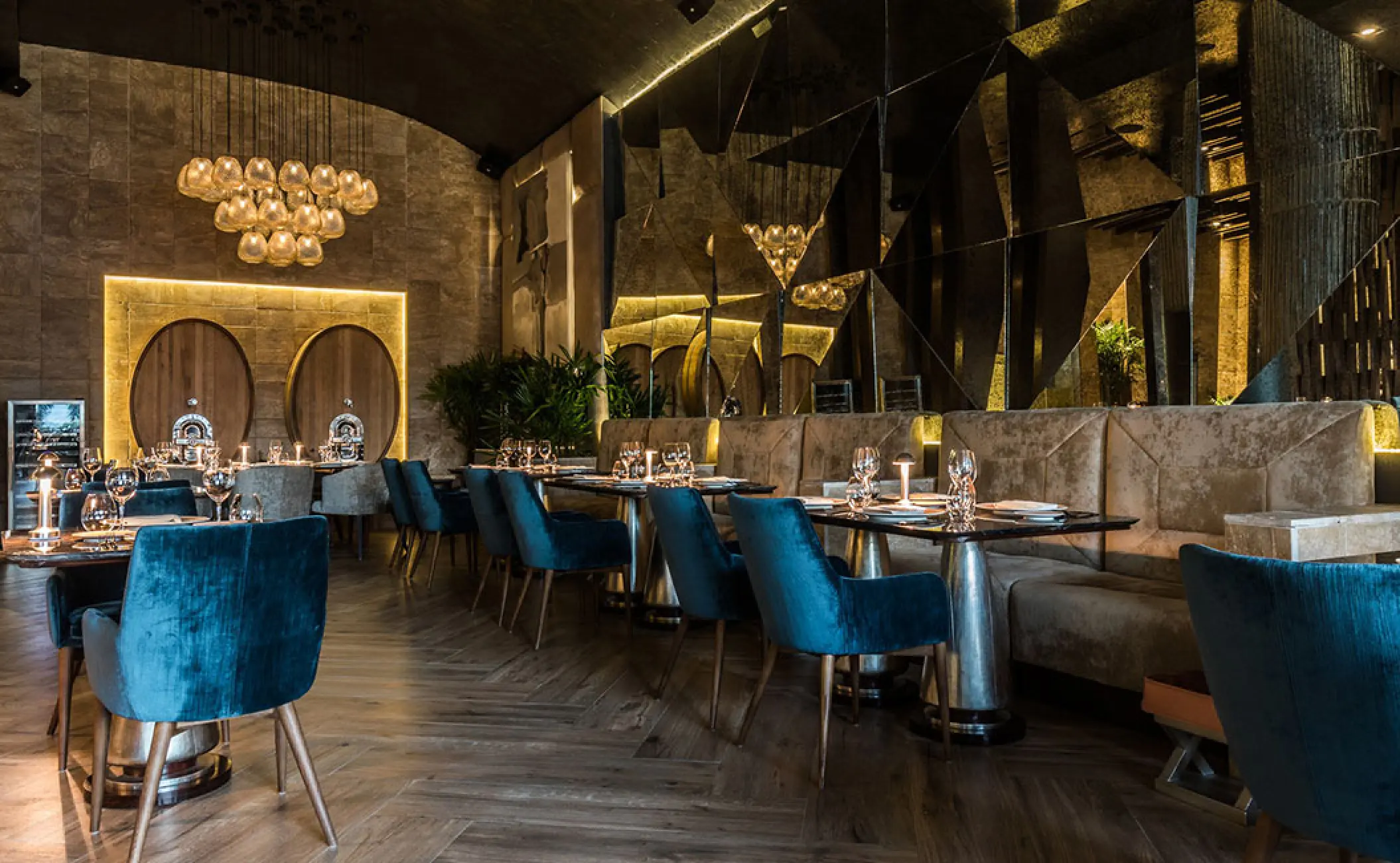 Lucca restaurant with blue velvet chairs and golden chandeliers at Grand Velas Riviera Nayarit, Puerto Vallarta