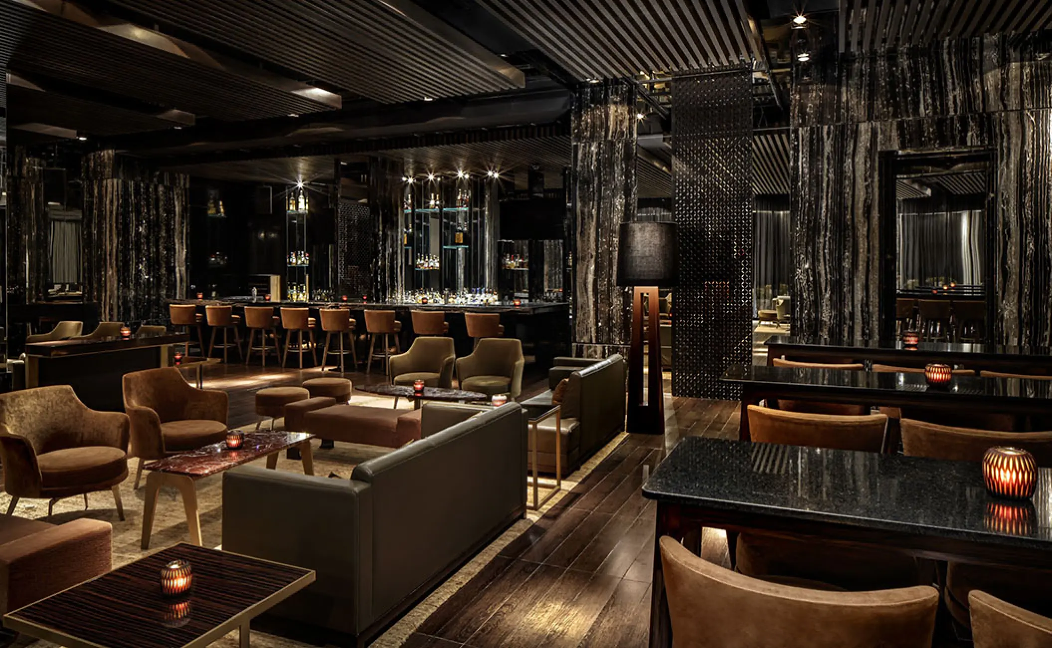 Modern lounge and bar area with dark wood floors at Grand Velas Riviera Nayarit, Puerto Vallarta
