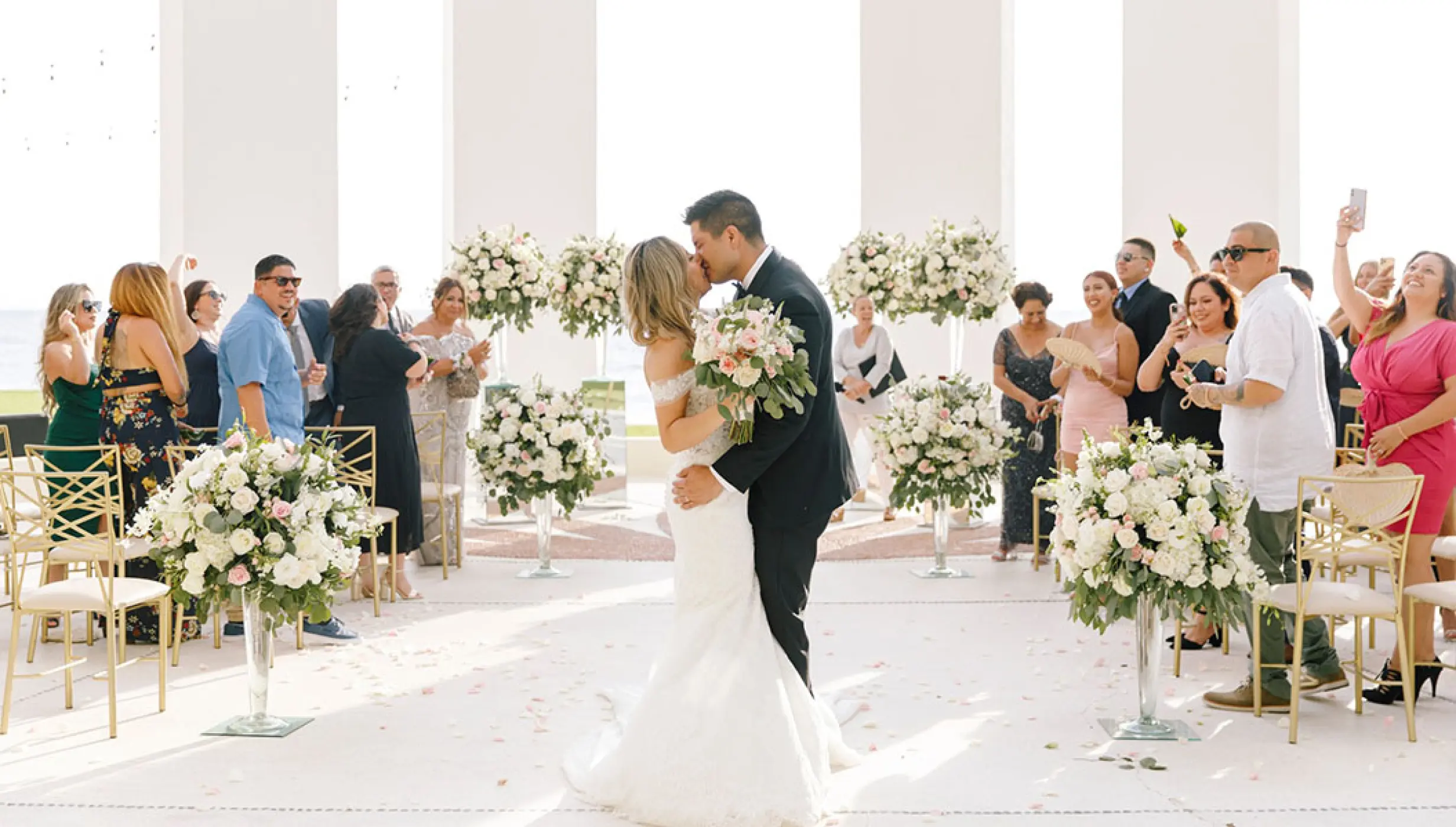 The couple kissing at their wedding ceremony at Grand Velas Riviera Nayarit, Puerto Vallarta