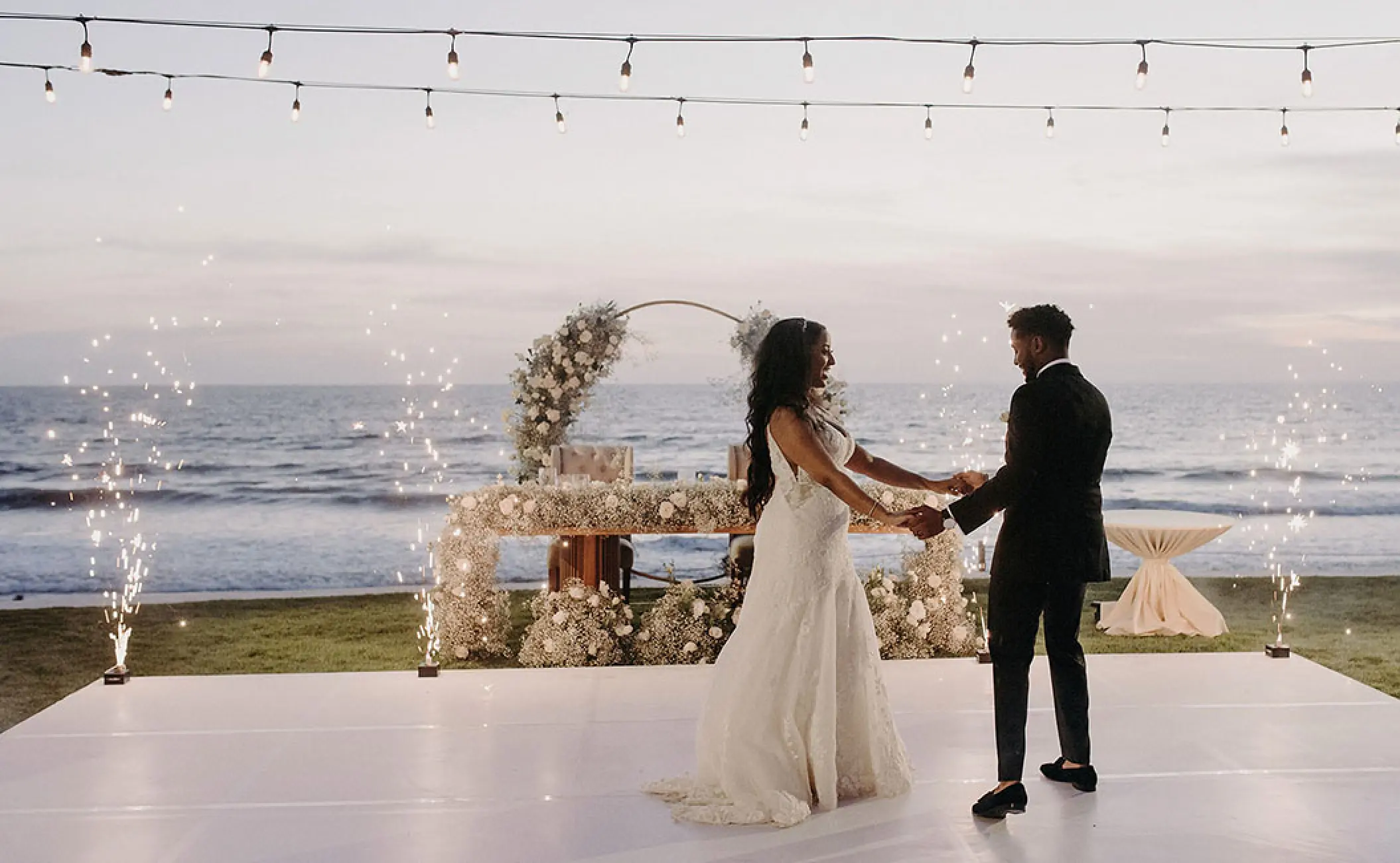 The couple's first dance on a white beachfront dance floor at Grand Velas Riviera Nayarit, Puerto Vallarta