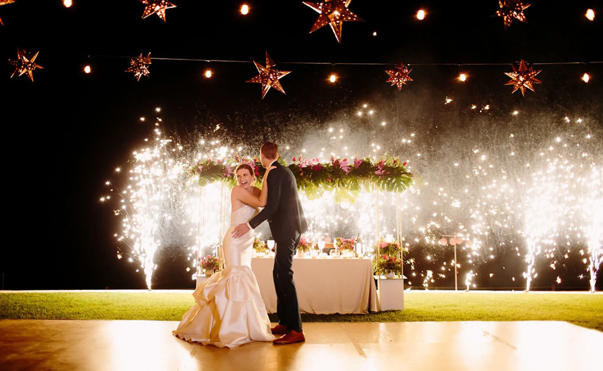 Newlyweds dancing at an outdoor reception with cold sparkler fountains at Grand Velas Riviera Nayarit, Puerto Vallarta