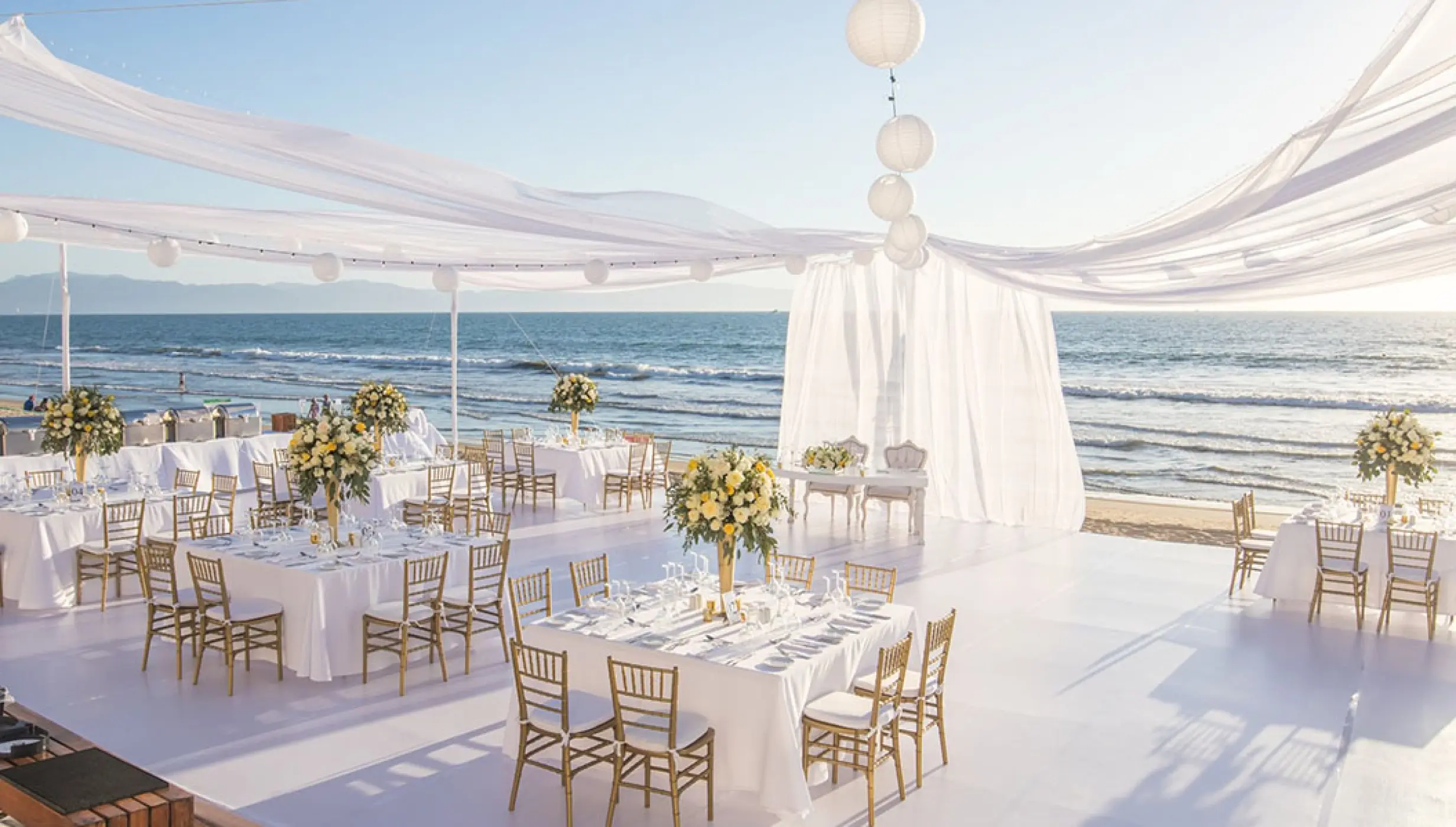 Beachfront wedding reception setup with white drapery at Grand Velas Riviera Nayarit, Puerto Vallarta