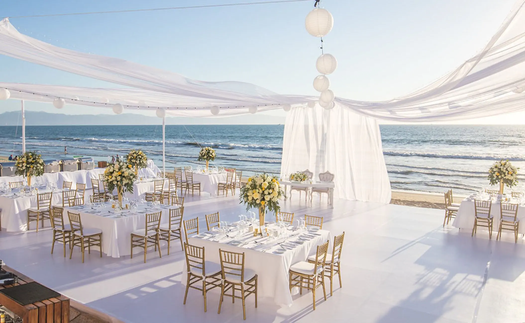 Beachfront wedding reception setup with white drapery at Grand Velas Riviera Nayarit, Puerto Vallarta