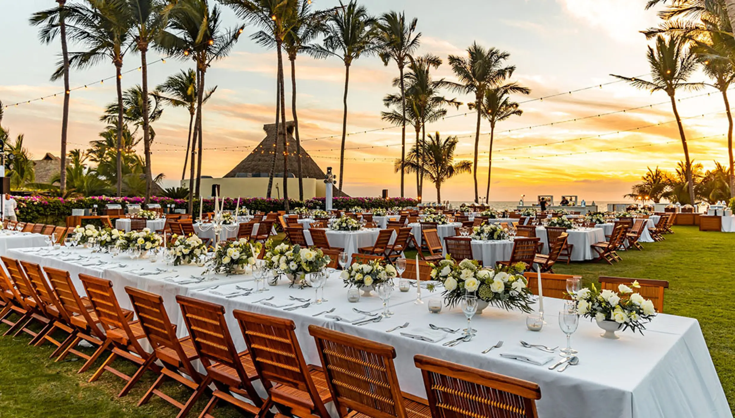 Outdoor wedding reception with long banquet tables and floral centerpieces at Grand Velas Riviera Nayarit, Puerto Vallarta