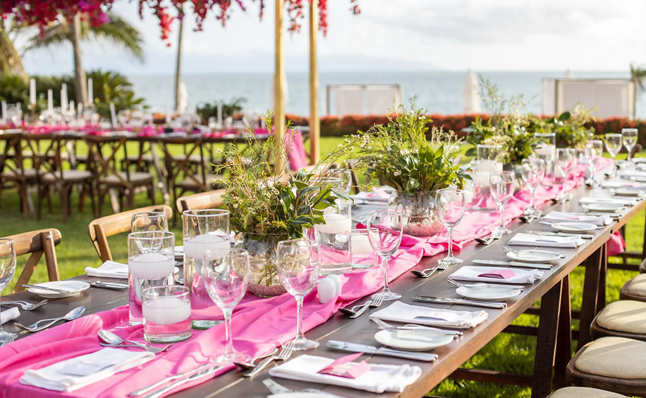 Garden wedding reception setup with pink runners and greenery at Grand Velas Riviera Nayarit, Puerto Vallarta