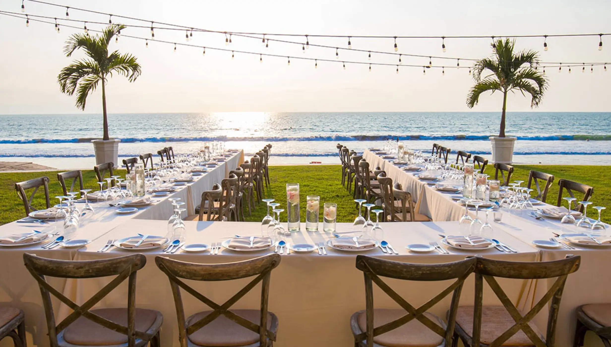 Garden wedding reception at Grand Velas Riviera Nayarit with oceanfront tables and string lights, Puerto Vallarta