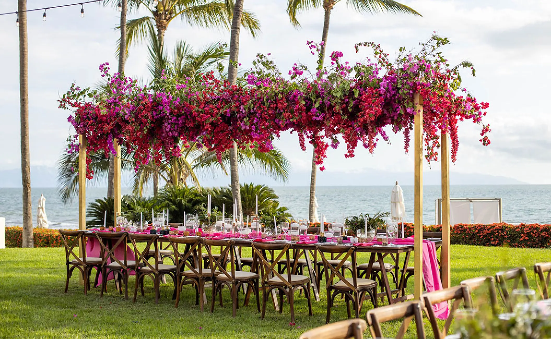 Garden wedding reception setup with bougainvillea floral canopy at Grand Velas Riviera Nayarit, Puerto Vallarta