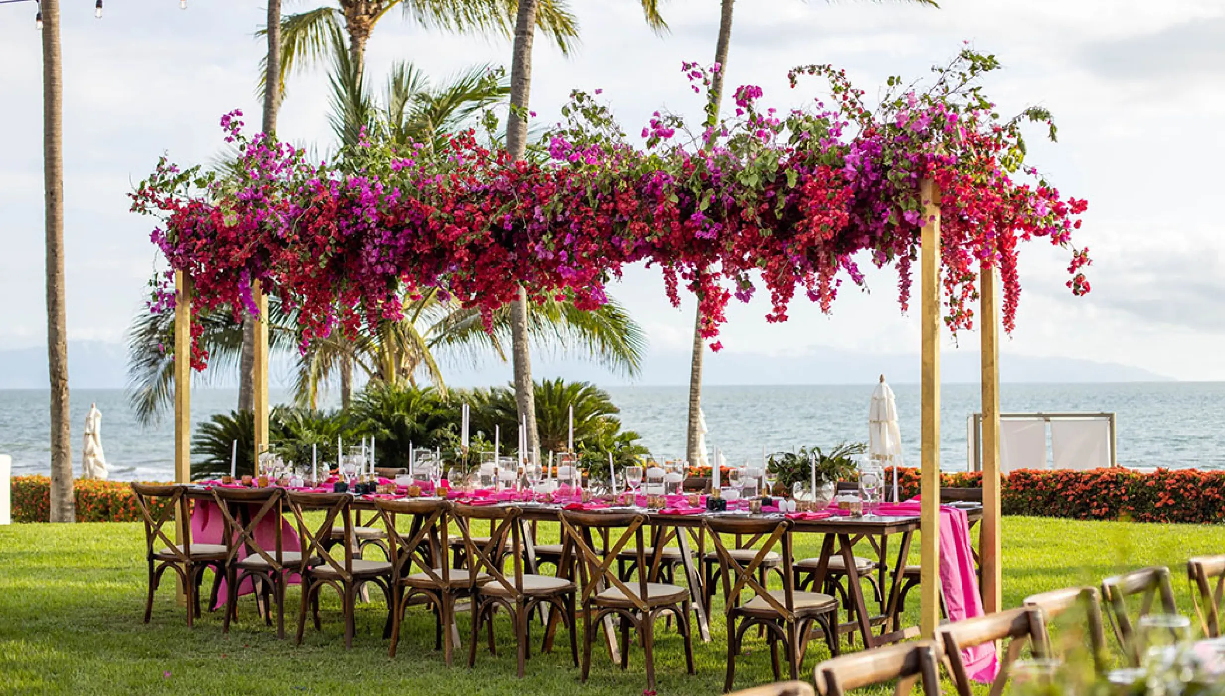 Garden wedding reception setup with bougainvillea floral canopy at Grand Velas Riviera Nayarit, Puerto Vallarta