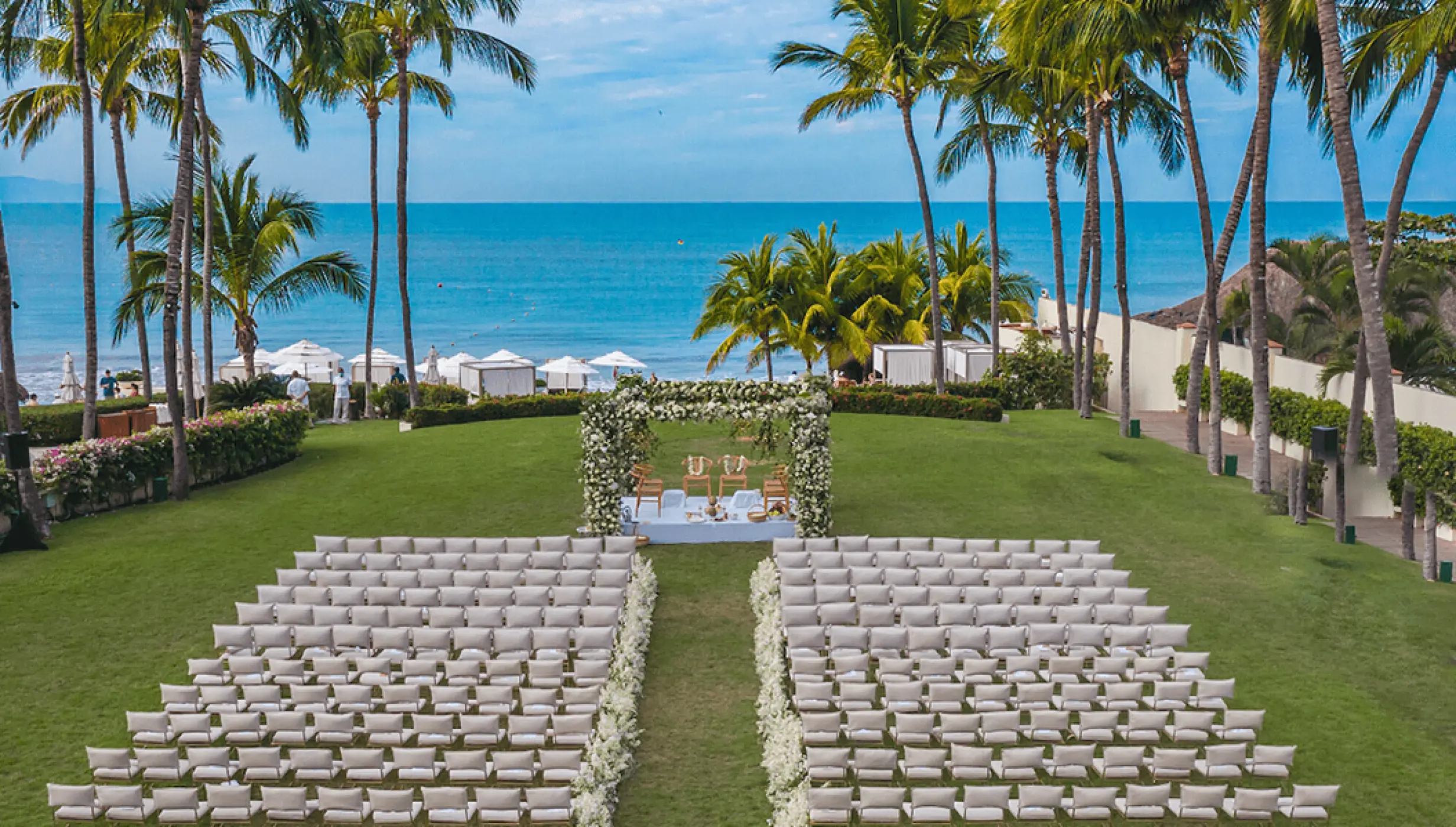 Ocean garden wedding ceremony with white floral arch at Grand Velas Riviera Nayarit, Puerto Vallarta
