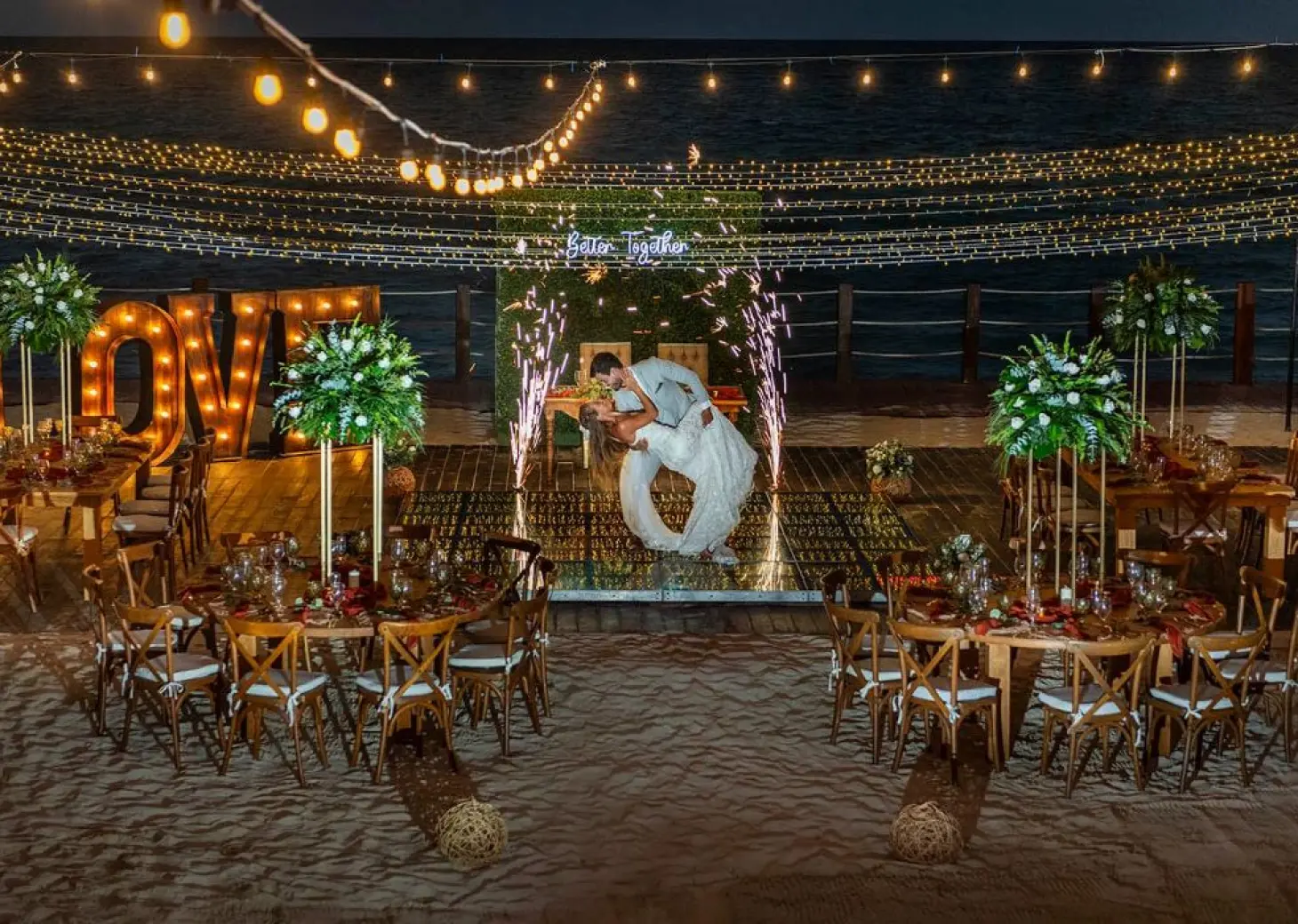 bride and groom at their reception on the beach at Ocean Maya Royale