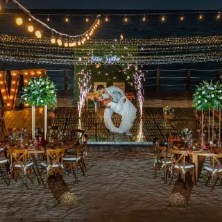 bride and groom at their reception on the beach at Ocean Maya Royale