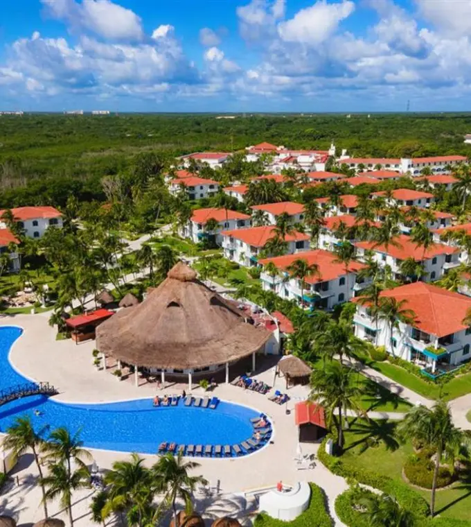Aerial view of swimming pools and red-roofed villas at H10 Ocean Maya Royale, Riviera Maya