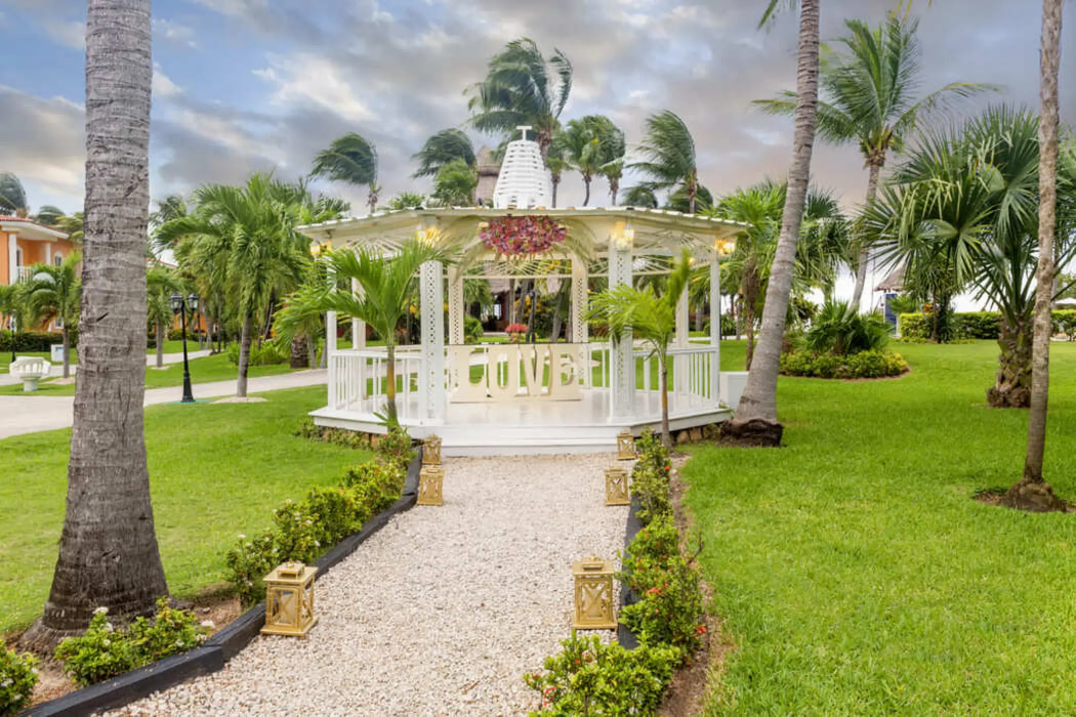 White garden gazebo wedding venue with floral accents at Ocean Maya Royale, Riviera Maya