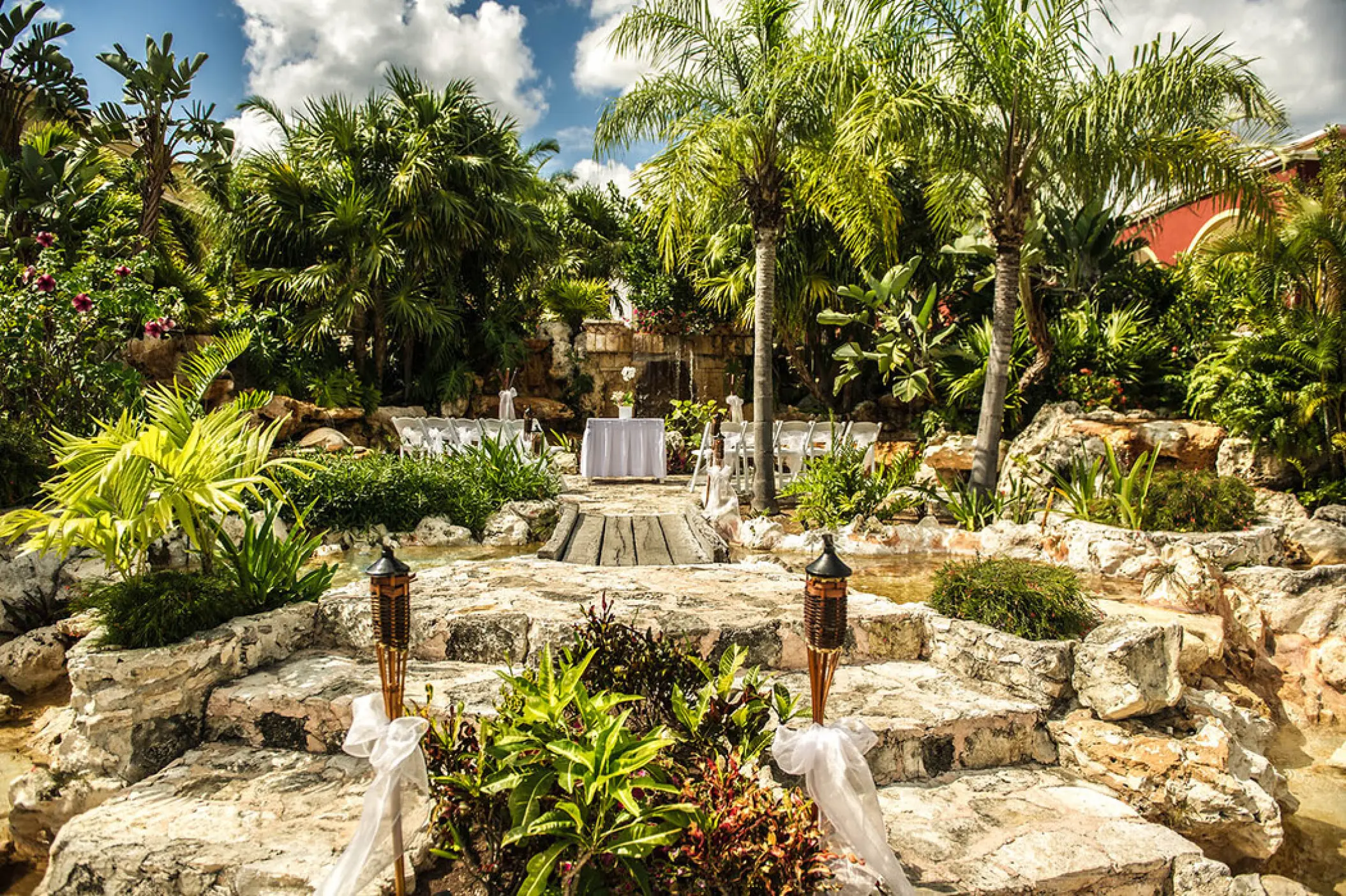 Waterfalls wedding ceremony venue with tropical greenery at Ocean Maya Royale, Riviera Maya