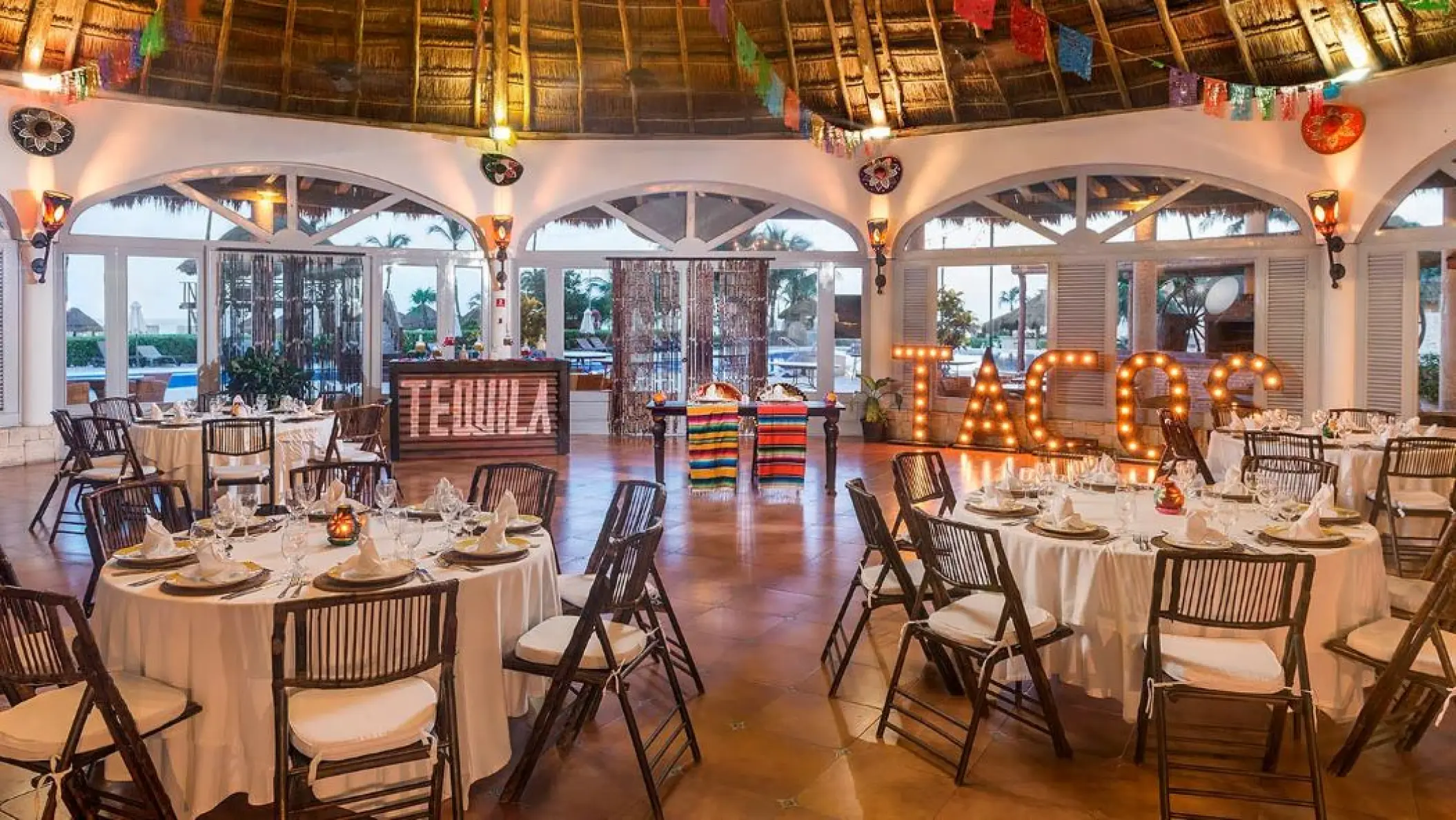 Mexican-themed wedding reception setup with taco and tequila bars at Ocean Maya Royale, Riviera Maya