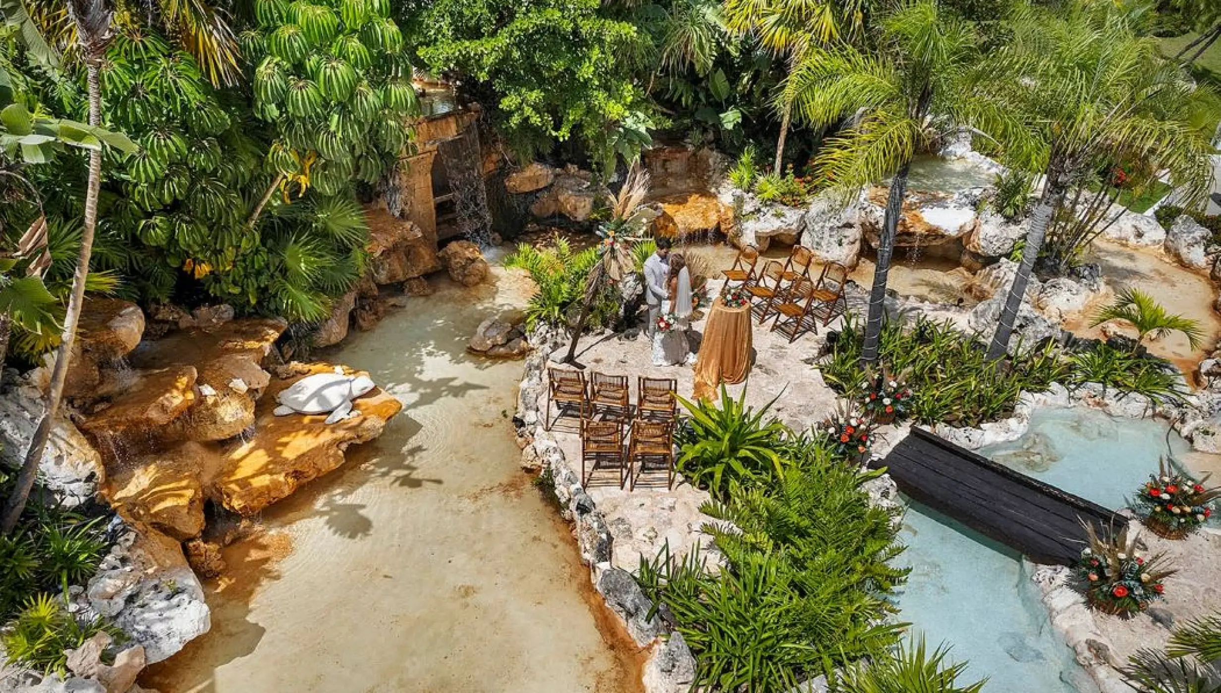 bride and groom at the waterfalls venue at Ocean Maya Royale