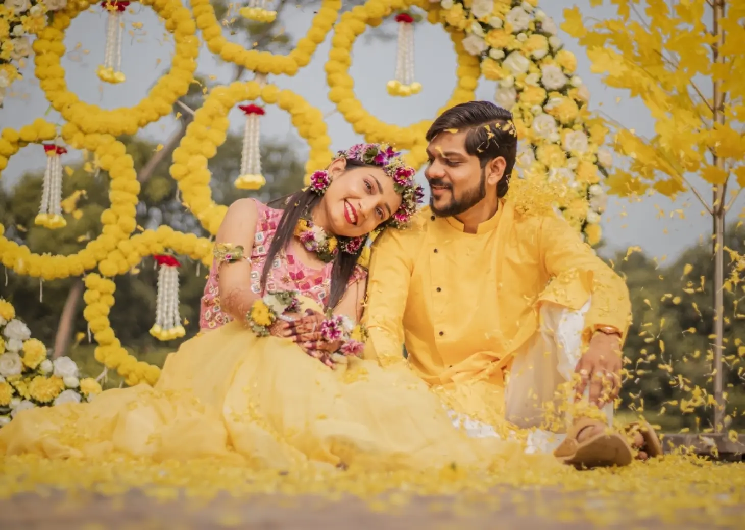 Couple at a Haldi ceremony with yellow floral decor at Secrets Tides, Punta Cana