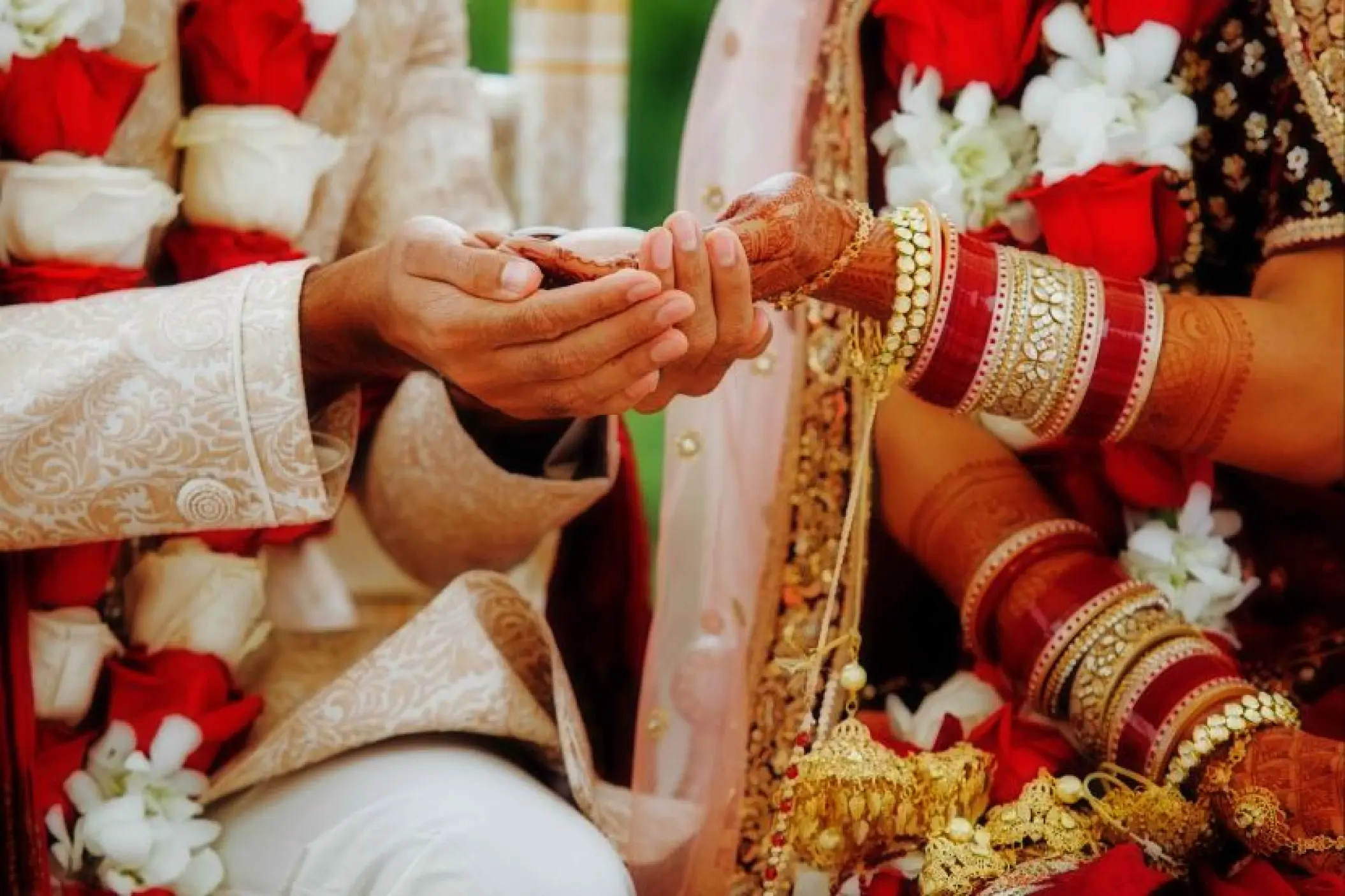 Close-up of the couple's hands during a traditional Indian wedding ceremony at Secrets Tides, Punta Cana