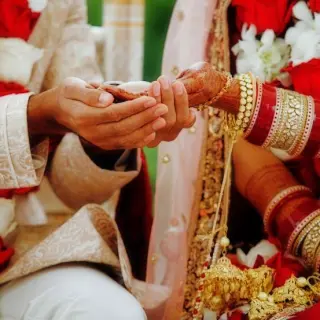 Close-up of the couple's hands during a traditional Indian wedding ceremony at Secrets Tides, Punta Cana