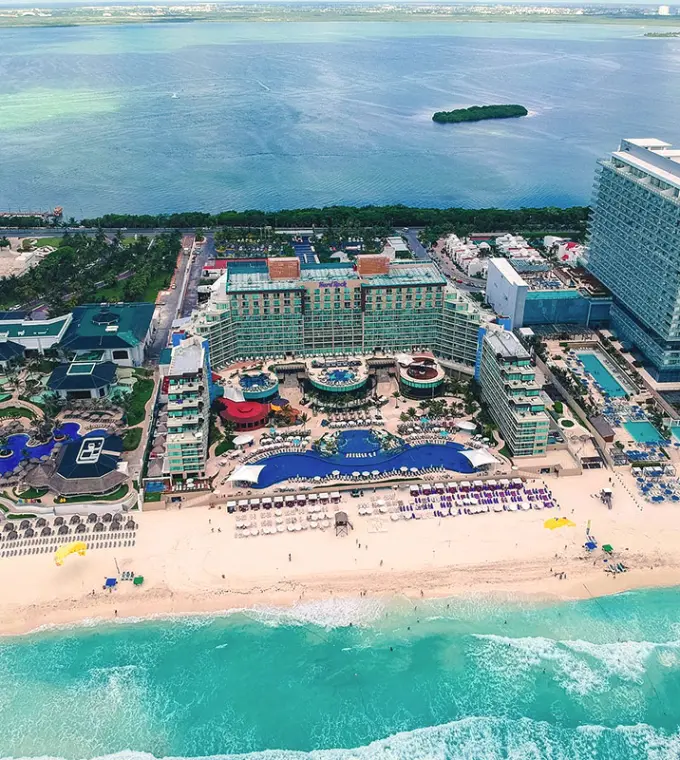 Aerial view of Hard Rock Cancun pools and white sand beach between the Caribbean Sea and Nichupté Lagoon